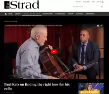 man playing cello, with other man interviewing