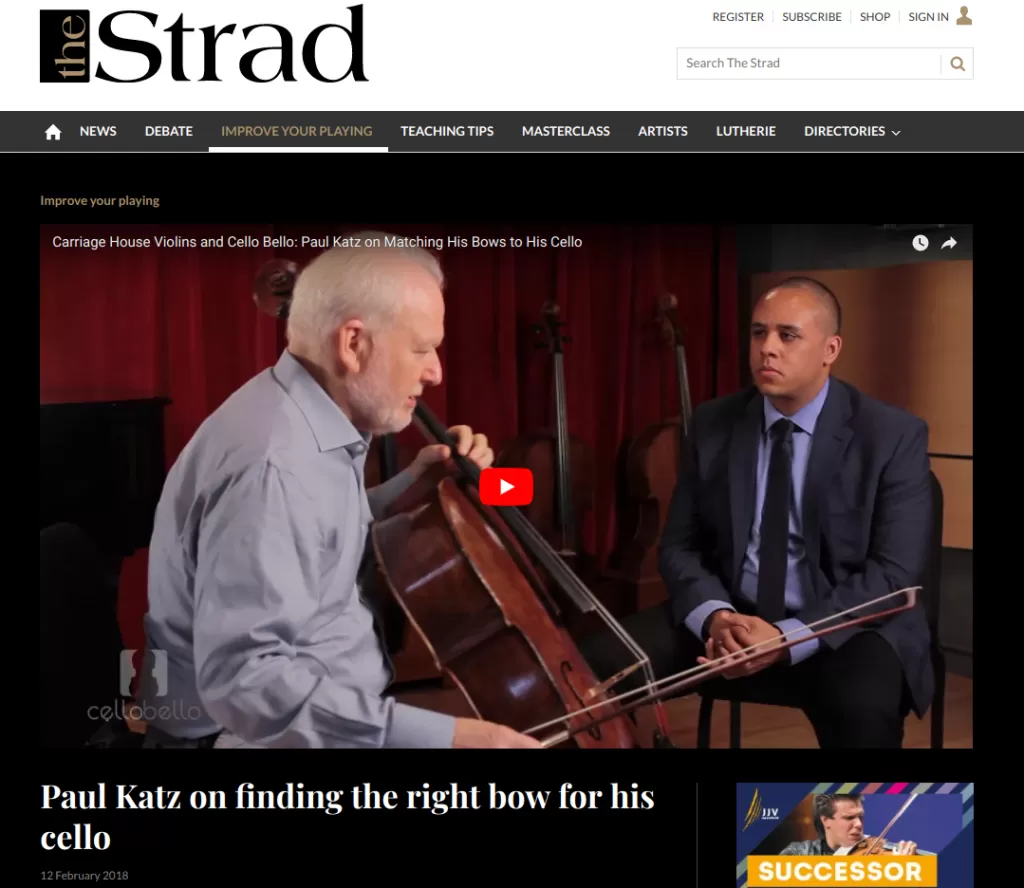 man playing cello, with other man interviewing